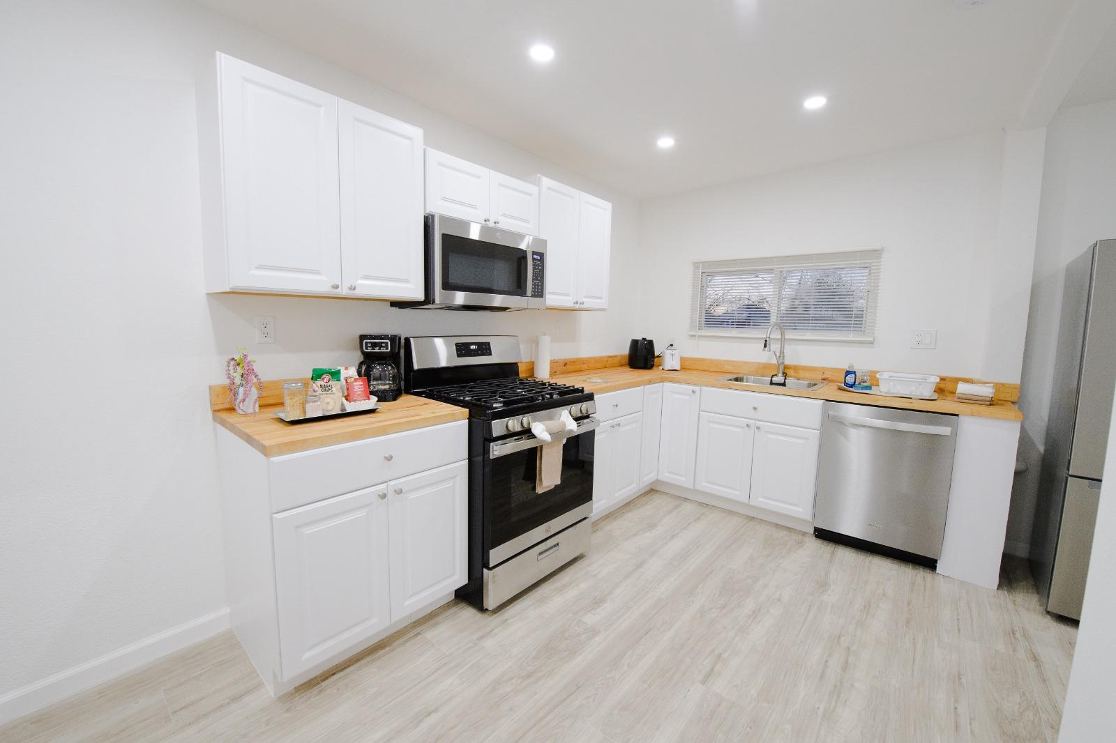 Modern white kitchen with butcher-block counters