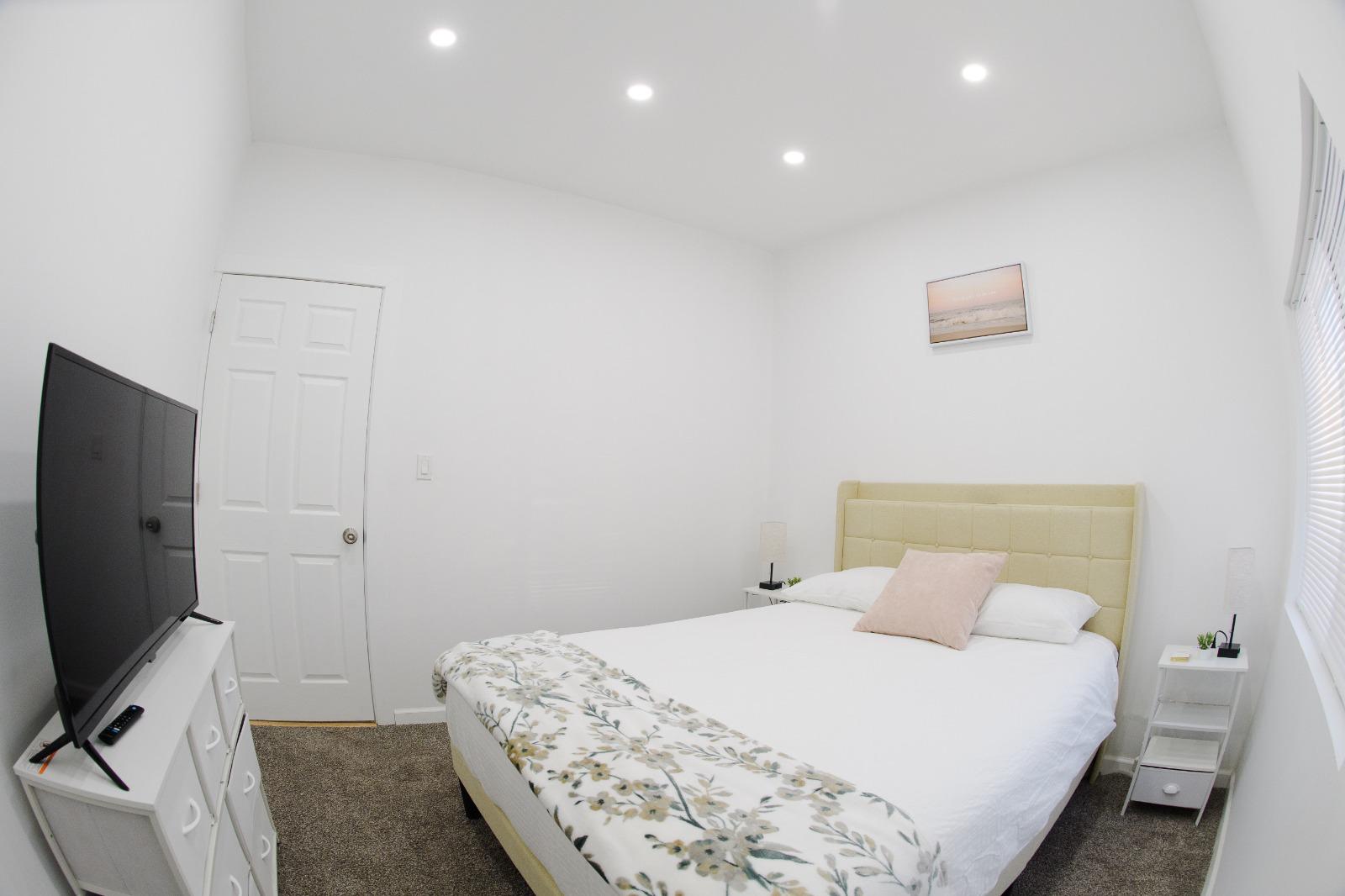 Cozy bedroom with TV and dresser