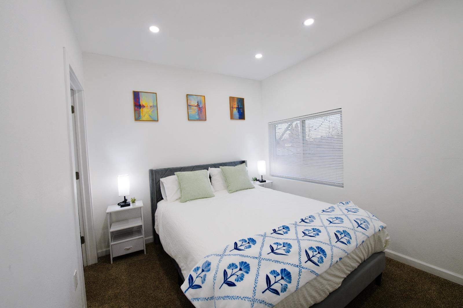 Bedroom with artwork and nightstands