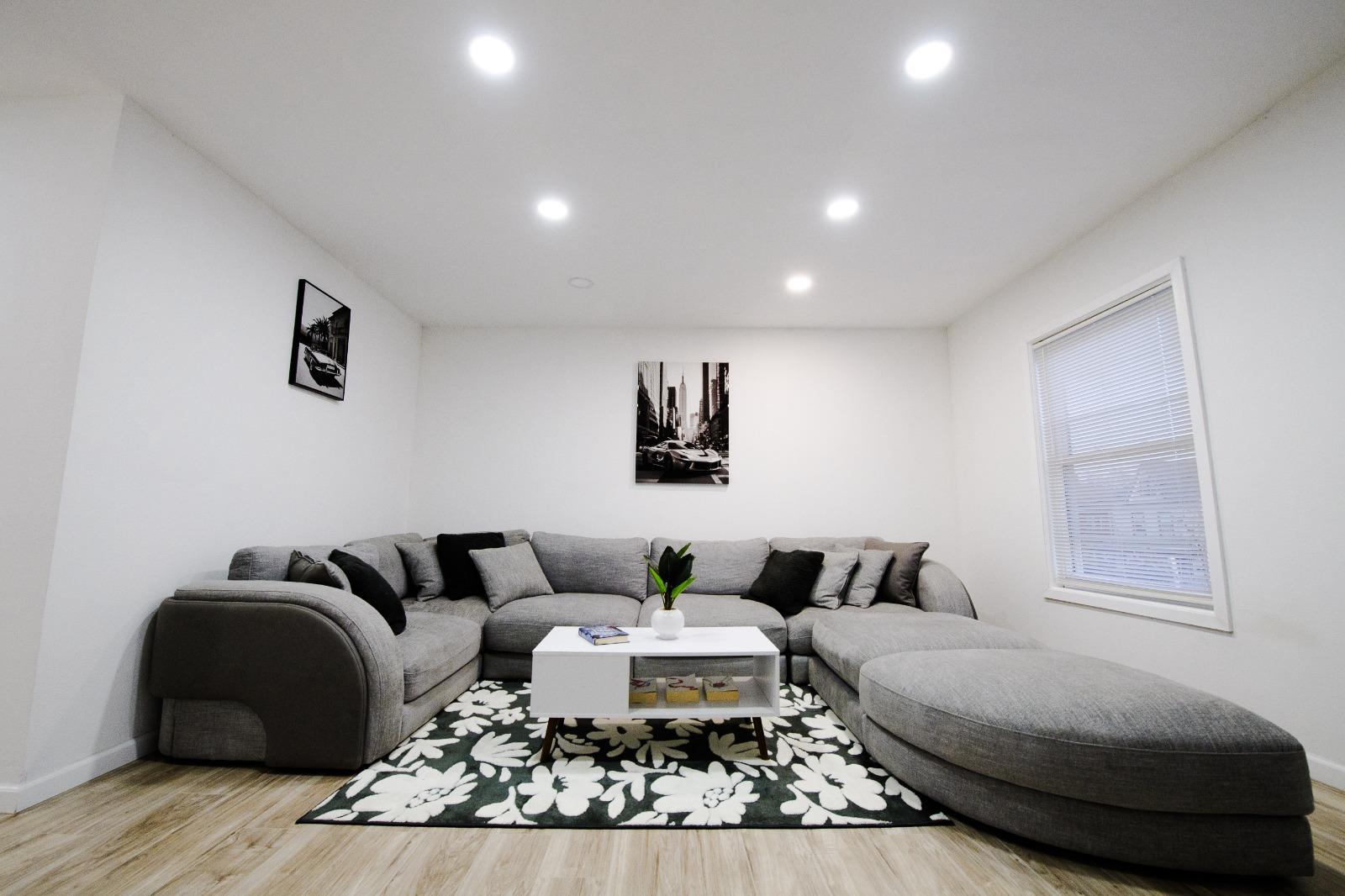 Large living room with sectional and rug